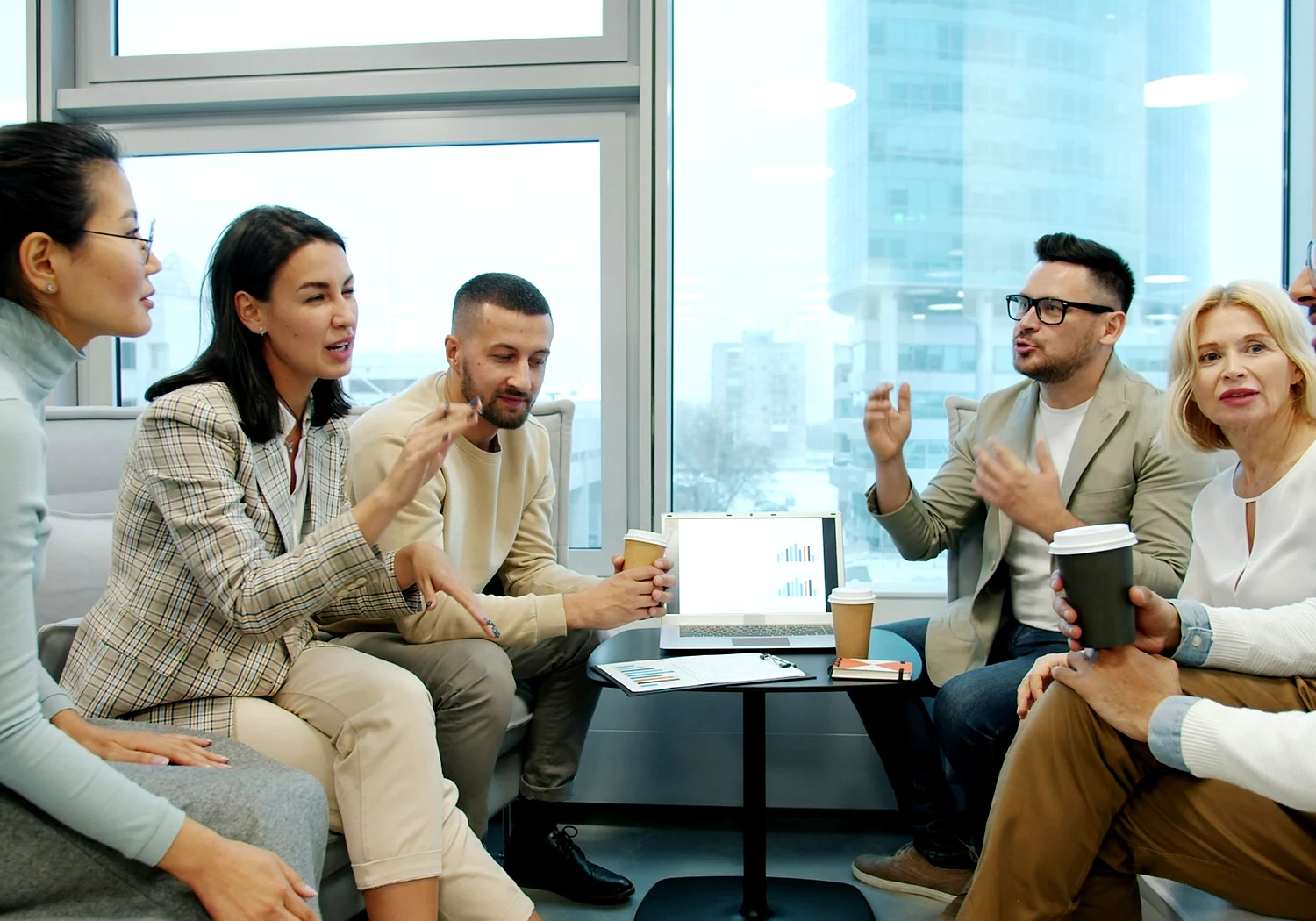 MRZ advisors collaborating around a table in a bright Ajman office