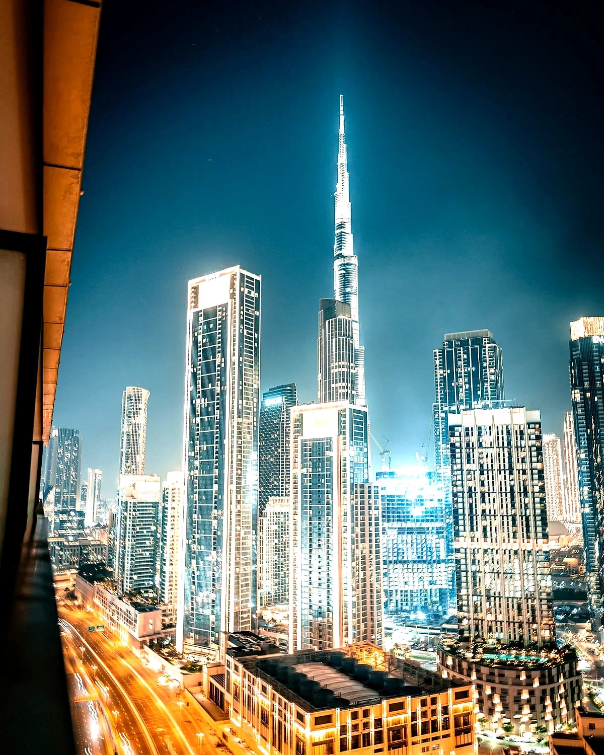 Dubai skyline lit up at night with the Burj Khalifa