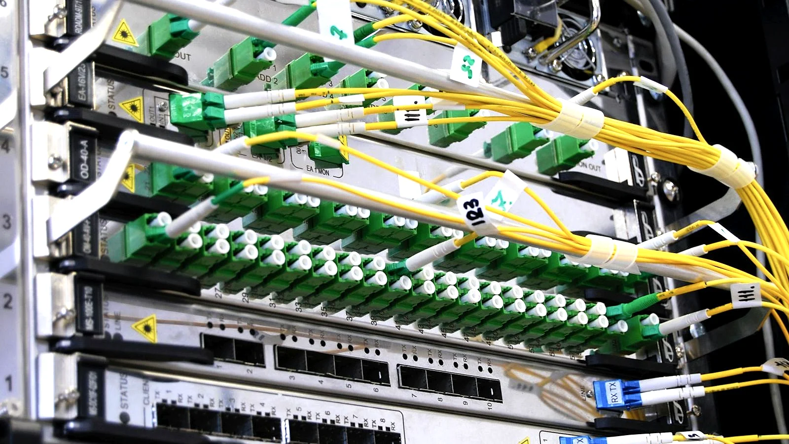 Fibre-optic network cables connected to a server rack in a data centre
